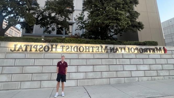 A.J. Clark stands beside the Metropolitan Methodist Hospital sign